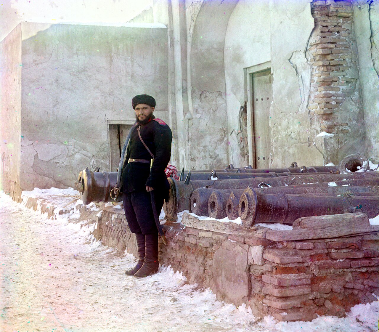 A sentry at the Emir's palace in Bukhara, with old cannon, photographed by Sergei Prokudin-Gorsky between 1905 and 1915
